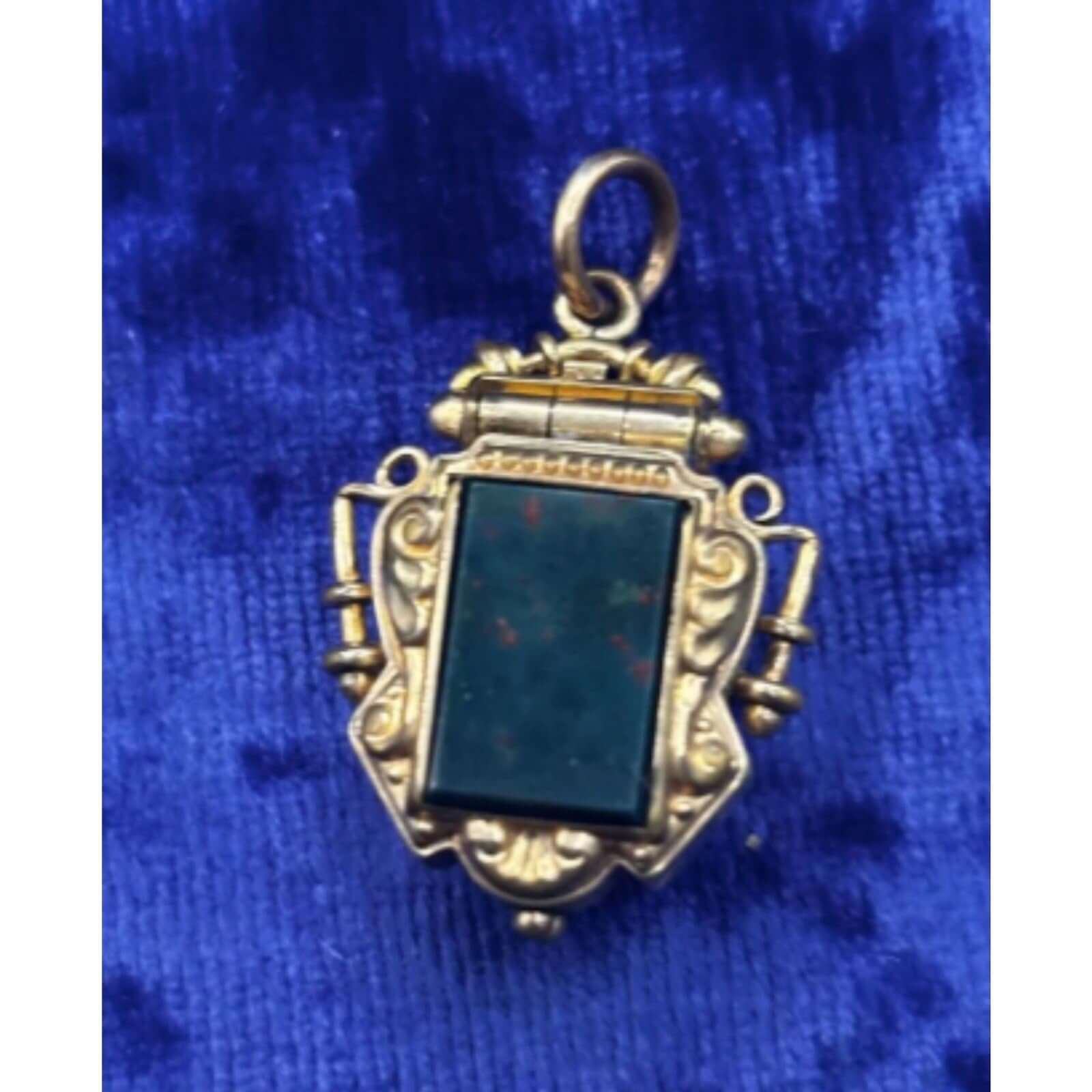 Antique 19th Century Victorian 10K Gold Carved Tiger's Eye & Bloodstone Locket on blue velvet background.